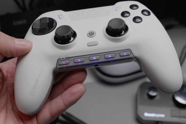 White Scuf wireless gaming controller in hand with worn thumbsticks
