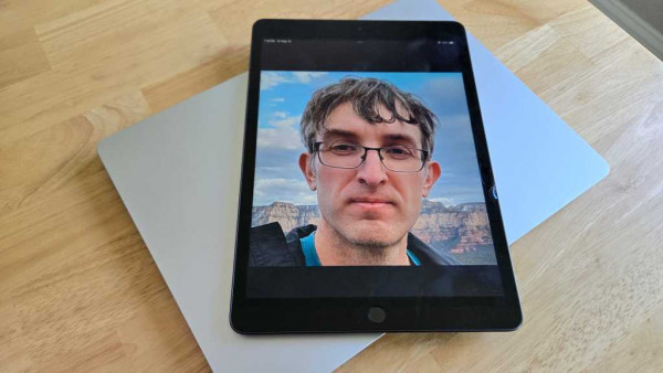 iPad with Chris Hoffman face photo on Surface Laptop