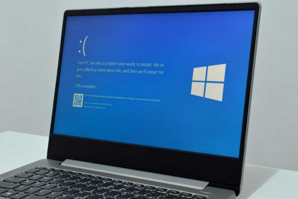 Pasuruan, Indonesia - July 20, 2024: Laptop displays blue screen of death or BSOD on the monitor screen. Faulty Microsoft Windows operating system. Blue screen of death